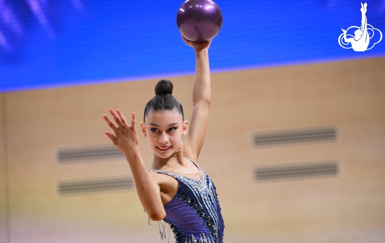 Гимнастка во время упражнения с мячом