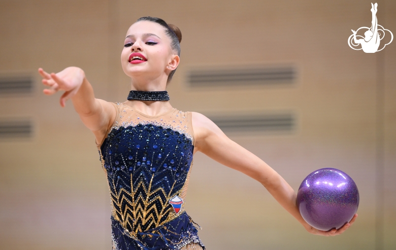 Гимнастка во время упражнения с мячом